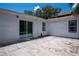 Back patio with sliding glass doors and view of the backyard at 1906 E Idlewild Ave, Tampa, FL 33610