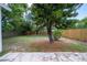 Expansive backyard with a tall wooden fence and mature trees at 1906 E Idlewild Ave, Tampa, FL 33610
