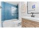 Modern bathroom with blue tiled shower, stylish vanity, and contemporary fixtures at 1906 E Idlewild Ave, Tampa, FL 33610