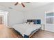 This bedroom features wood floors, a window, and a ceiling fan at 1906 E Idlewild Ave, Tampa, FL 33610