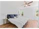 Bedroom features a plush bed, hardwood floors, and natural light at 1906 E Idlewild Ave, Tampa, FL 33610