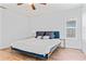 This bedroom features wood floors, a window, and a ceiling fan at 1906 E Idlewild Ave, Tampa, FL 33610
