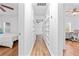 Hallway with built-in shelving and hardwood floors connecting bedrooms and an office space at 1906 E Idlewild Ave, Tampa, FL 33610