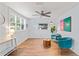 Bright living room boasts luxury vinyl flooring, modern fan, decor, and lots of natural light at 1906 E Idlewild Ave, Tampa, FL 33610