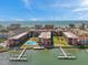 Condominium complex featuring a community pool, dock access, and Gulf of Mexico beach access at 19701 Gulf Blvd # 210, Indian Shores, FL 33785