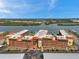 Panoramic aerial view of Bay Mariner condos, showcasing waterfront location and lush landscaping under a clear blue sky at 19701 Gulf Blvd # 210, Indian Shores, FL 33785