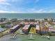 Waterfront condominium complex featuring a community pool, dock access, and views of the ocean at 19701 Gulf Blvd # 210, Indian Shores, FL 33785