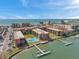 Condominium complex featuring a community pool, dock access, and views of the Gulf of Mexico at 19701 Gulf Blvd # 210, Indian Shores, FL 33785