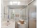 Bright bathroom with a vanity, a mirror, and a shower with sliding glass doors at 19701 Gulf Blvd # 210, Indian Shores, FL 33785