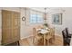 Cozy dining area features a wooden table set for six, with natural light enhancing the inviting space at 19701 Gulf Blvd # 210, Indian Shores, FL 33785