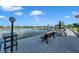 Relaxing waterfront area with an expansive dock, grill, picnic table, and serene water views at 19701 Gulf Blvd # 210, Indian Shores, FL 33785