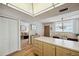 Open concept kitchen with light wood cabinets, and a view of the dining area and living room at 19701 Gulf Blvd # 210, Indian Shores, FL 33785