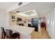 Kitchen features ample counter space, wooden cabinets, and modern appliances with barstool seating area at 19701 Gulf Blvd # 210, Indian Shores, FL 33785