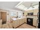 Bright kitchen with lots of counter space, featuring an island, wooden cabinets and modern appliances at 19701 Gulf Blvd # 210, Indian Shores, FL 33785