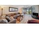 Spacious living room with sectional sofa and sliding glass doors to the outdoor area at 19701 Gulf Blvd # 210, Indian Shores, FL 33785