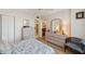 Comfortable bedroom with ample storage, a ceiling fan, and a private entrance to the ensuite bathroom at 19701 Gulf Blvd # 210, Indian Shores, FL 33785
