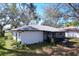 Backyard with partial view of home and screened porch at 2004 Nobleton Ave, Spring Hill, FL 34608