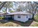 View of the backyard featuring the home and an enclosed porch at 2004 Nobleton Ave, Spring Hill, FL 34608