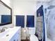 Clean bathroom with tiled shower, modern vanity, and blue accents at 2004 Nobleton Ave, Spring Hill, FL 34608