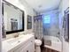 Bathroom showcasing a shower-tub combo with stylish shower curtain and single sink vanity at 2004 Nobleton Ave, Spring Hill, FL 34608