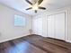 Bedroom featuring wood-look floors, ceiling fan, and closet at 2004 Nobleton Ave, Spring Hill, FL 34608