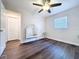 Bright bedroom featuring wood-look flooring and a ceiling fan at 2004 Nobleton Ave, Spring Hill, FL 34608