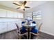 Bright dining area with modern cabinets, stylish table with blue chairs, and elegant lighting at 2004 Nobleton Ave, Spring Hill, FL 34608