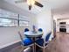 Cozy dining area featuring a round table with blue chairs, a window, and modern finishes at 2004 Nobleton Ave, Spring Hill, FL 34608
