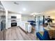 View of the kitchen showcasing stainless steel appliances, white cabinetry, and an open floor plan at 2004 Nobleton Ave, Spring Hill, FL 34608