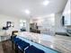 Open kitchen with an island and seating, stainless steel appliances and a view of the dining area at 2004 Nobleton Ave, Spring Hill, FL 34608