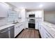 Modern kitchen with white cabinetry, stainless steel appliances, and subway tile backsplash at 2004 Nobleton Ave, Spring Hill, FL 34608