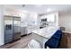 Bright, modern kitchen with stainless steel appliances, a center island, and a breakfast bar with stools at 2004 Nobleton Ave, Spring Hill, FL 34608