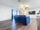 View of a well-lit living room leading to the kitchen and dining area, complete with a flat screen TV at 2004 Nobleton Ave, Spring Hill, FL 34608