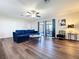 Bright living room with a large window and a screen door leading to the outside area at 2004 Nobleton Ave, Spring Hill, FL 34608