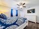 Well-lit main bedroom featuring dark floors, a TV, and a white dresser at 2004 Nobleton Ave, Spring Hill, FL 34608