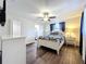 Bright bedroom features dark wood floors and ensuite bathroom at 2004 Nobleton Ave, Spring Hill, FL 34608