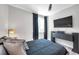 Modern bedroom with dark accents, a TV, dark curtains, and light wood floors at 2140 Catalina Dr, Clearwater, FL 33764