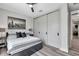 Modern bedroom featuring light wood floors, large windows, a skyline art piece, and modern furnishings at 2140 Catalina Dr, Clearwater, FL 33764