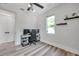 Bright bedroom with a ceiling fan, a window, light wood floors, and an adjacent door at 2140 Catalina Dr, Clearwater, FL 33764