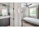Ensuite bathroom with a modern vanity and an open view to the bright, minimalist bedroom at 2140 Catalina Dr, Clearwater, FL 33764