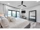 Bright bedroom with a gray loveseat, a balcony entrance, a ceiling fan, and light wood floors at 2140 Catalina Dr, Clearwater, FL 33764