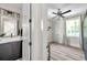 Ensuite bathroom with a modern vanity and an open view to the bright, minimalist bedroom at 2140 Catalina Dr, Clearwater, FL 33764
