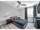 Modern bedroom featuring a platform bed, sleek black furniture, and plenty of natural light from the large window at 2140 Catalina Dr, Clearwater, FL 33764