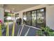 An inviting covered patio with outdoor seating, sliding glass doors, and a view of the backyard at 2140 Catalina Dr, Clearwater, FL 33764