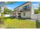 Modern two-story home boasts a balcony, covered patio, and well-manicured lawn at 2140 Catalina Dr, Clearwater, FL 33764