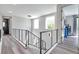Hallway with modern railings, and hanging lights, leading to bedrooms and living spaces at 2140 Catalina Dr, Clearwater, FL 33764