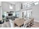 Spacious open-concept living area with stylish furniture, dining area, staircase, and abundant natural light at 2140 Catalina Dr, Clearwater, FL 33764
