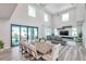 Open-concept living and dining area with high ceilings, large windows, and a view of the outdoor space at 2140 Catalina Dr, Clearwater, FL 33764