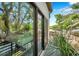 View from the rooftop deck showing sliding glass doors to the bedroom and privacy trees at 2140 Catalina Dr, Clearwater, FL 33764