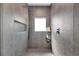 Contemporary shower with gray tile, built-in niche, and rainfall shower head at 2140 Catalina Dr, Clearwater, FL 33764